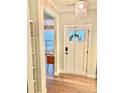 Bright entryway featuring a stylish front door, hardwood floors, and modern lighting at 1477 Micahs Way N, Spring Lake, NC 28390