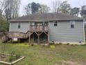 The back of the house has a nice sized deck, with stairs to the yard and an outdoor seating area underneath at 1504 Kentucky Ave, Sanford, NC 27332