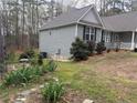 A well maintained home with a landscaped side yard with mature trees and plants at 1504 Kentucky Ave, Sanford, NC 27332