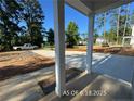 Covered front porch featuring sturdy white columns and a view of the surrounding yard at 205 Regis Ln, Coats, NC 27521