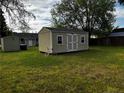 Spacious backyard featuring a storage shed, offering additional storage for tools and equipment at 107 Mars Dr, Dunn, NC 28334