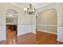 Elegant dining room featuring hardwood floors, wainscoting, and arched doorways at 1176 Micahs N Way, Spring Lake, NC 28390