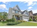 Beautifully landscaped front yard with a two-story home and inviting curb appeal at 1176 Micahs N Way, Spring Lake, NC 28390