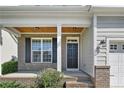 Inviting front porch with brick accents and stylish black front door at 1176 Micahs N Way, Spring Lake, NC 28390