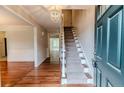 Bright foyer with hardwood floors, a staircase, and a decorative chandelier at 1312 Gormly Cir, Sanford, NC 27330