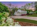 Inviting home exterior with blooming flowers, a spacious driveway, and lush greenery at 1312 Gormly Cir, Sanford, NC 27330