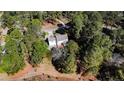 An overhead perspective of a home enveloped by a canopy of trees, showcasing its secluded setting at 172 Green Links Dr, Cameron, NC 28326