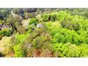Lush, green trees engulf the home in a beautiful wooded area at 2007 Windmill Dr, Sanford, NC 27330