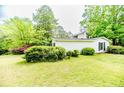 Well-maintained home with charming details, lush greenery, and a manicured lawn at 2007 Windmill Dr, Sanford, NC 27330