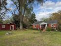 Spacious backyard featuring a red storage shed and a cozy fire pit at 216 Pendergraft Rd, Bunnlevel, NC 28323