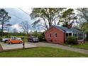 Wide shot of the house exterior highlighting the driveway and screen porch at 216 Pendergraft Rd, Bunnlevel, NC 28323