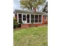 Close up of charming front porch with brick steps and screened windows at 216 Pendergraft Rd, Bunnlevel, NC 28323