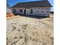 Exterior rear of home with windows and doors installed, showing the house wrap layer at 45 Blackgum Ct, Spring Lake, NC 28390