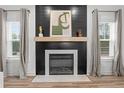 Modern fireplace with elegant tile surround and stylish mantel at 496 Persimmon Tree Dr, Cameron, NC 28326