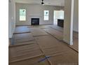 Spacious living room with a cozy fireplace and abundant natural light from multiple windows at 55 Blackgum Ct, Spring Lake, NC 28390