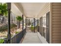 Inviting covered porch with stylish railings, decorative plants, and wood accents at 76 Silver Lake Pt, Sanford, NC 27332