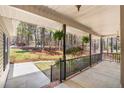 Cozy covered porch with hanging ferns, providing a relaxing outdoor space at 76 Silver Lake Pt, Sanford, NC 27332