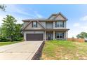 Inviting two-story home with a well-maintained lawn and a convenient two-car garage at 10 N Dakota Ct, Spring Lake, NC 28390