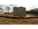 Simple two story home with neutral siding and large windows surrounded by a dirt lot at 106 Driftwood Ct, Sanford, NC 27330
