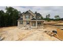 New construction home boasts neutral siding, black roof, covered porch, and ample natural light at 106 Driftwood Ct, Sanford, NC 27330