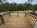 Spacious wooden deck with sturdy railing, perfect for outdoor relaxation and entertainment at 182 Horse Trot Ln, Sanford, NC 27332