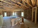 Spacious, unfinished interior featuring wood framing, insulation, and plenty of natural light at 182 Horse Trot Ln, Sanford, NC 27332