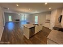 Open-concept kitchen with island, granite countertops, stainless steel appliances, and hardwood floors at 182 Horse Trot Ln, Sanford, NC 27332
