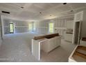 Spacious, unfinished living room featuring drywall walls, multiple windows, and a sliding glass door at 182 Horse Trot Ln, Sanford, NC 27332