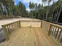 New wooden back deck overlooks the partially cleared lot at 28 Horse Trot Ln, Sanford, NC 27332