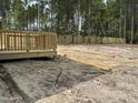 Backyard featuring a newly constructed wooden deck and a fresh wooden fence at 28 Horse Trot Ln, Sanford, NC 27332