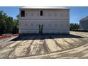 Unfinished two-story home exterior, construction materials visible on siding, with foundation and dirt foreground at 28 Horse Trot Ln, Sanford, NC 27332