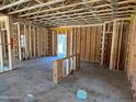 Unfinished interior view showcases exposed framing and concrete flooring in a spacious new construction at 28 Horse Trot Ln, Sanford, NC 27332