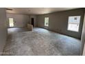 Unfinished living room with new windows and access to the backyard at 28 Horse Trot Ln, Sanford, NC 27332