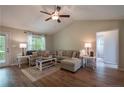 Bright living room featuring a comfortable sectional sofa, wood floors and neutral decor at 40 Patricia S Vann Ct, Dunn, NC 28334
