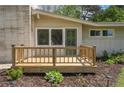 Close up of a cozy front porch with a wooden railing and stylish outdoor lighting at 107 Pandora Cir, Erwin, NC 28339