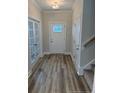 Light and bright entryway with luxury vinyl plank flooring and a view of the front door at 112 Surles Landing Way, Benson, NC 27504