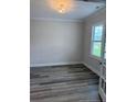 Office area with luxury vinyl plank flooring, view of backyard, and glass french doors at 112 Surles Landing Way, Benson, NC 27504