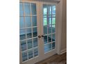 Office area with luxury vinyl plank flooring, view of backyard, and glass french doors at 112 Surles Landing Way, Benson, NC 27504