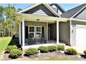 Inviting front porch with rocking chairs and neatly landscaped garden at 120 Will Lucas Rd, Linden, NC 28356