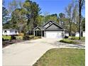 Well-manicured lawn leads to a charming single-story home with an ample driveway and two-car garage at 120 Will Lucas Rd, Linden, NC 28356