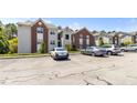 Multiple cars are parked in the parking lot, providing a sense of community and convenience at 124 Gallery Dr # 302, Spring Lake, NC 28390