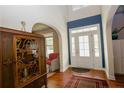 Bright foyer with wood floors, high ceilings, and elegant glass paneled front door at 126 Islay Dr, Cameron, NC 28326