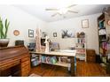 Cozy home office with wood floors, unique desk, and ample shelving for organization at 126 Islay Dr, Cameron, NC 28326