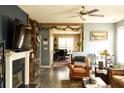 Comfortable living room with fireplace, TV, hardwood floors, and open dining area at 186 Kentucky Derby Ln, Lillington, NC 27546