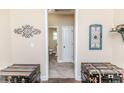 Hallway with carpet floor leading to a bathroom at 276 Widgeon Way, Lillington, NC 27546