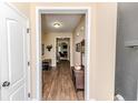 Hallway with hardwood floors leading to living areas and bedrooms at 276 Widgeon Way, Lillington, NC 27546