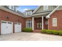 Close-up of an elegant brick home highlighting the columned entrance at 30 Spring Pond Ln, Spring Lake, NC 28390
