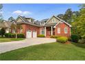 Beautiful brick home featuring a two car garage and manicured lawn at 30 Spring Pond Ln, Spring Lake, NC 28390