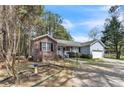 Beautiful home showcasing brick and siding, complemented by mature trees and a well-maintained front yard at 6138 St Andrews Dr, Sanford, NC 27332