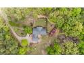 An aerial view reveals a well-maintained home with a landscaped yard surrounded by mature trees at 9301 Nc 27, Lillington, NC 27546